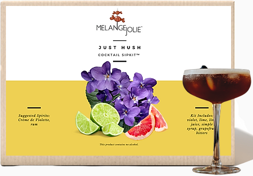 Mélange Jolie Just Hush Cocktail SipKit™ featuring a coupe glass, bar spoon, edible violets, and cocktail ingredients.